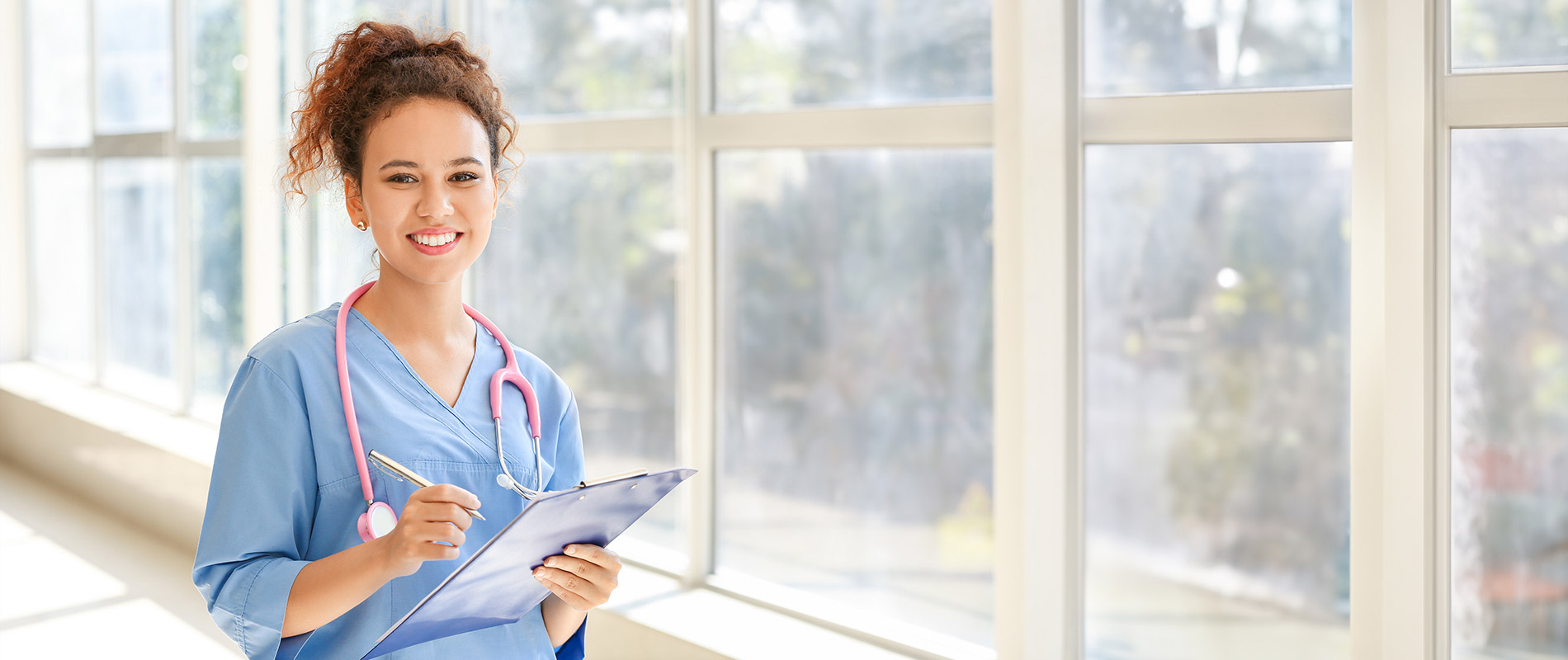 female 英雄联盟博彩竞猜 Practical Nursing student in scrubs